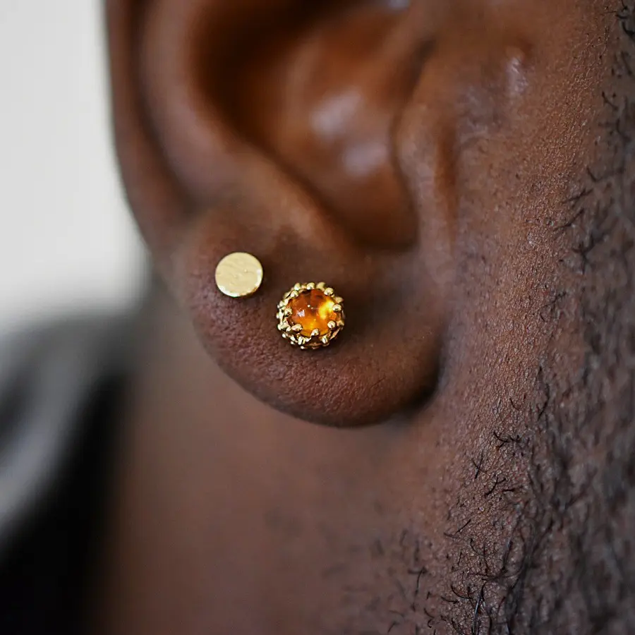 Close-up of an ear with two piercings